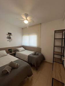 Posteľ alebo postele v izbe v ubytovaní Apartamentos CT