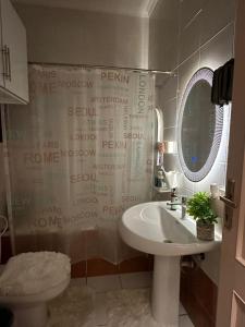 a bathroom with a sink and a toilet and a mirror at CRAFT LOFT - Amber 232 in Jeddah