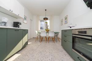 a kitchen with a table and chairs in it at Apartments Pepi in Mali Lošinj