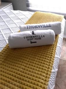 two towels sitting on top of a bed at Thornville Guesthouse Gold in Pietermaritzburg