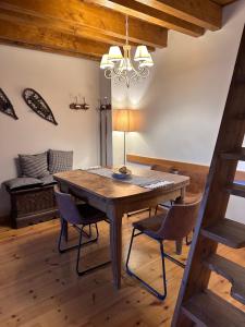 a dining room with a wooden table and chairs at Lo somni del riu in Llavorsí
