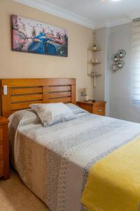 a bedroom with a bed and a picture on the wall at New Apartment Alejandro in Torre del Mar +11 photos