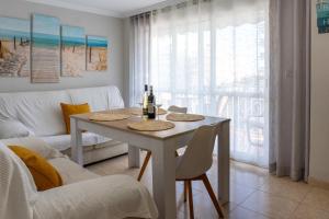 a living room with a white table and chairs at New Apartment Alejandro in Torre del Mar