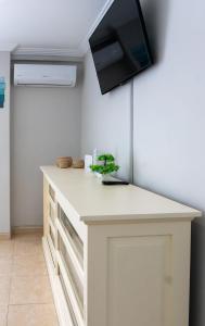 a kitchen with a counter with a tv on the wall at New Apartment Alejandro in Torre del Mar