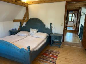 a bedroom with a blue bed with two night tables at Chalupa Ostrůvek in Tachov
