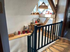 a room with a staircase with a wooden shelf and a window at Chalupa Ostrůvek in Tachov