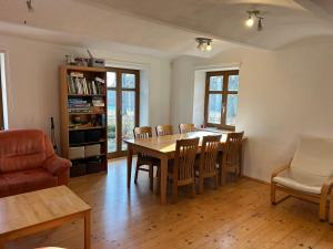 a living room with a dining room table and chairs at Chalupa Ostrůvek in Tachov +20 photos
