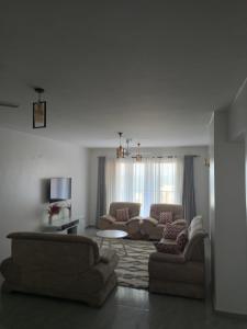 a living room with two couches and a table at Luxurious apartments Mombasa in Mombasa