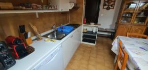 a kitchen with a sink and a stove at Mansarda Elena in Sestola