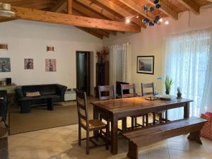 a living room with a wooden table and chairs at Oleiro de Cima in São Teotónio +15 photos