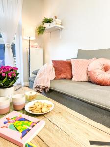 a living room with a couch and a table at Apartamenty Prestige Harmony Rosiczkowa in Augustów