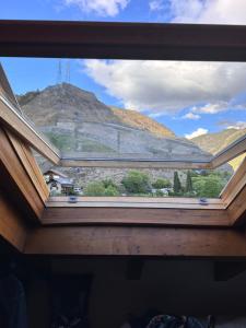 a view of a mountain from a window at Lo somni del riu in Llavorsí