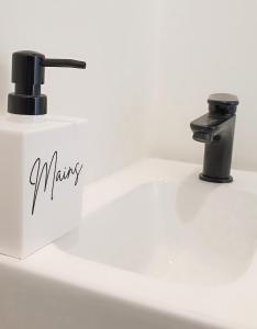 a sink with a faucet in a bathroom at La Villa des Dunes bord de mer in Loctudy +13 photos