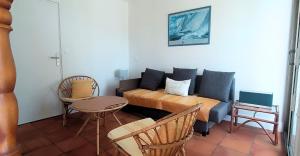 a room with a bed and a couch and a table at La Villa des Dunes bord de mer in Loctudy