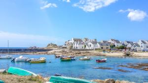 a group of boats in a body of water with houses at La Villa des Dunes bord de mer in Loctudy