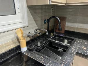 un comptoir de cuisine avec un évier dans une cuisine dans l'établissement comfort, à Madinaty 3 autres photos