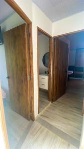 an empty room with two doors and a mirror at Cabaña Pocho in Aguazul +4 photos