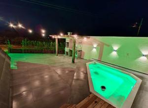 a jacuzzi tub on a patio at night at Nova cabana com jacuzzi perto do mar in Arroio do Silva
