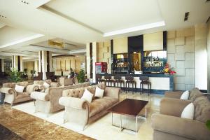 a lobby with couches and chairs and a bar at Muong Thanh Grand Quang Nam in Tam Kỳ