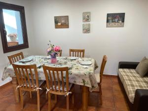 a dining room table with chairs and flowers on it at Casa da Greta in Parada del Monte +8 photos