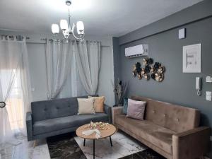 a living room with a couch and a table at Duba Apartments 2 in Alexandroupoli