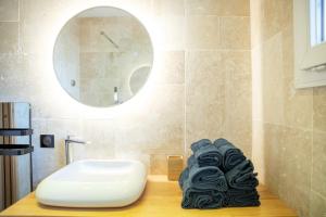 a bathroom with a white sink and a pile of towels at Antibes Old Town Haven in Antibes +74 photos