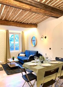 a living room with a table and a blue couch at Antibes Old Town Haven in Antibes