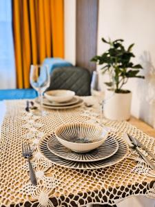 a table with plates and utensils on a table cloth at St Sava Legendary House in Veliko Tŭrnovo