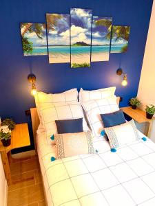 a bedroom with a white bed and a blue wall at Antibes Old Town Haven in Antibes