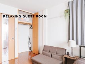 a living room with a couch and a living room guest room at Evergreen Apartment Hotel in Tokyo