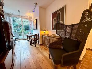 a living room with a chair and a table at Briller Palais in Wuppertal