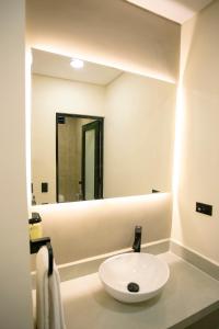 a bathroom with a white sink and a mirror at Hotel Gran Ester in Los Patios