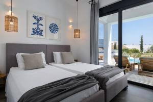 a bedroom with two beds and a view of the ocean at Seashell Villa - Luxury Pool Retreat - 150m Beach in Lachania