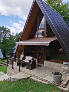 a house with a conservatory with couches and windows at Tara 1395 Altitude in Sekulić 