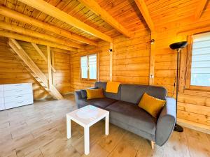 a living room with a couch and a table at Nadmorska Kępa in Kąty Rybackie