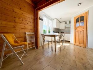 a kitchen and dining room with a table and chairs at Nadmorska Kępa in Kąty Rybackie +18 photos