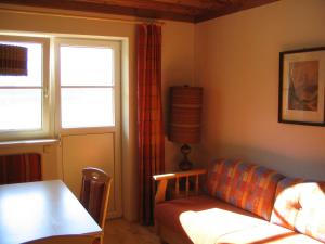a living room with a couch and a table at Pension Sarstein in Hallstatt