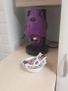 a pink coffee maker sitting on a counter with a bowl at A Mare in Vasto