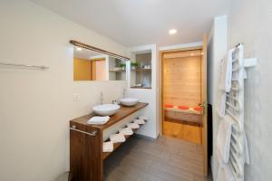 a bathroom with two sinks on a wooden counter at Alpinhotel Bort in Grindelwald +55 photos