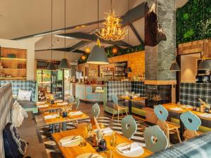 a restaurant with wooden tables and chairs at Ferienhaus in Schierke for 8 Personen in Schierke