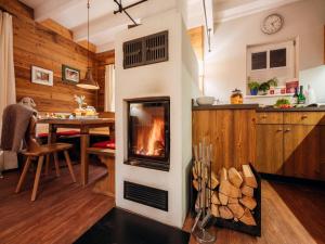 a fireplace in the middle of a kitchen with a table at Ferienhaus in Schierke for 7 Personen in Schierke +22 photos
