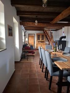 a dining room with a table and chairs at RIGLI vendégház in Závod