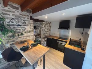 a kitchen with a wooden table in a room at Charmant appartement au Faouët in Le Faouët