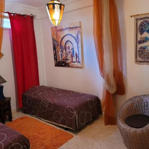 a living room with a ottoman in the corner at Villa du soleil in Mirleft +5 photos