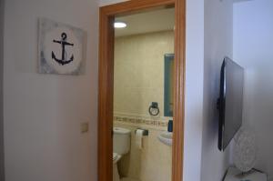 a bathroom with a toilet and a tub and a sink at Arbocer playa Puçol in Playa de Mar