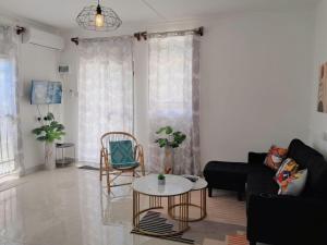 a living room with a couch and a table at Beach Pearl in Flic-en-Flac