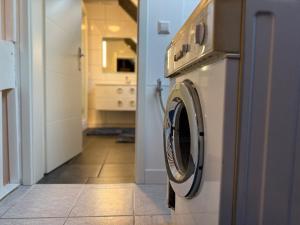 a washer and dryer in a kitchen with a hallway at Cleverland Appartement in Hannover