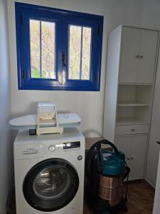 a washing machine in a room with a window at KERAME PARADISE VILLA in Agios Kirykos