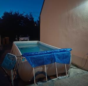 a swimming pool with a blue cover on a building at Entre terre et mer in Plédran