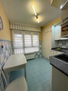 a kitchen with a table and a counter top at Haro Plaza Glam Tourist Home in Haro